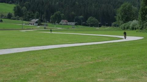 Cycling through an Austria mountain meadow scene Video stock 201222059