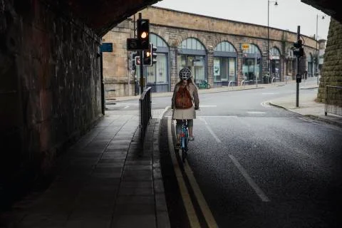 Cycling Under a Bridge to Work Stockfoto's