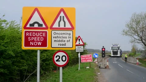 Cyclist and lorry passing through roadworks york united kingdom Stock Footage 143953451