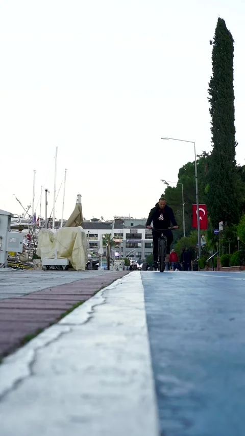Cyclist Approaching from Low Angle in Fethiye Park, Turkey, Dec 16, 2025 Stock Footage 324533157