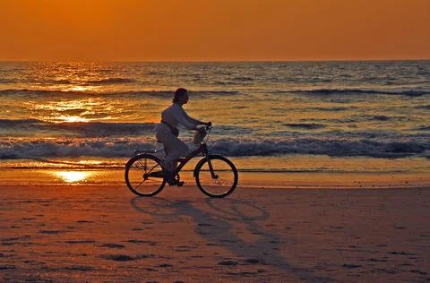 Cyclist on the beach Stock Photos