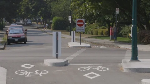 Cyclist in bike lane approaching intersection Stock Footage 103347682