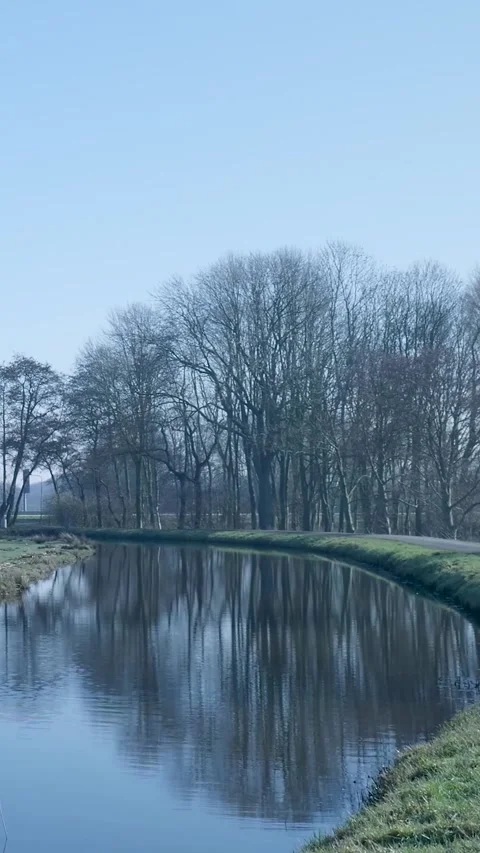 Cyclist biking along a tranquil towpath in early spring Stock-Footage 334424914