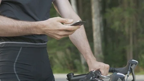 Cyclist checking his mobile phone on the ride Stock Footage 74543415