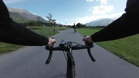 Cyclist Commuting Across Bridge and Overtaking Rider in Alpine Valley POV Stock Footage 336230102