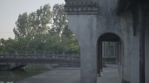 Cyclist crosses a bridge in a temple Stock Footage 286172468