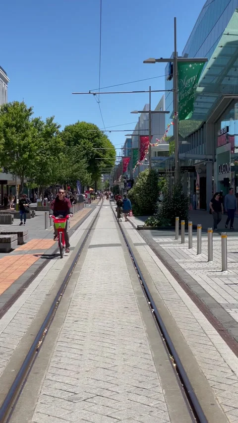 Cyclist cycle along tram way at Christchurch Central City Center Stock Footage 166370943