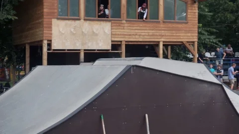 Cyclist does a trick on a springboard in the skate park Stock-Footage 103650581