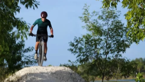 Cyclist Down Hilltop Around Bend Up Another Hilltop Stock Footage 203300093