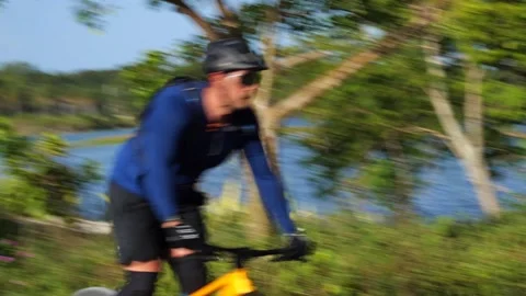 Cyclist Down Hilltop Around Bend Up Another Hilltop Stock Footage 203300186