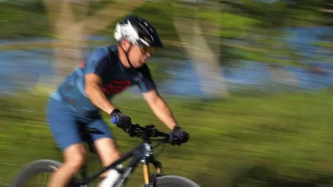 Cyclist Down Hilltop Around Bend Up Another Hilltop Stock Footage 203307811