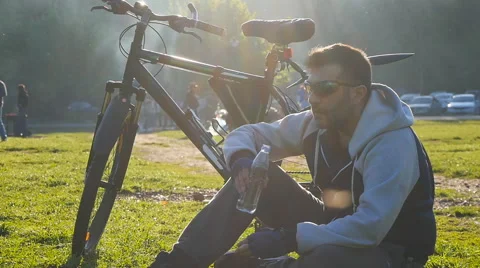 Cyclist is drinking water from the bottle Stock Footage 64834358