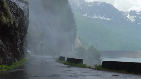 Cyclist driving under a waterfall Stock Footage 50969038
