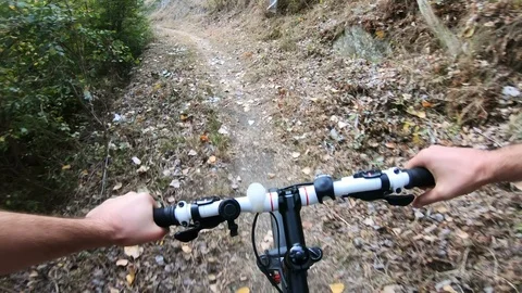 Cyclist during a mountain bike race in a forest, pov ride Stock Footage