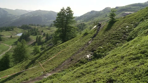 Cyclist going downhill on dirt patch Stock Footage 37587665