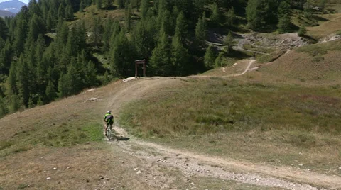 Cyclist going downhill on trail Stock Footage 37586943