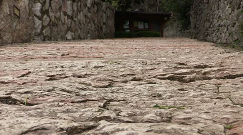 Cyclist going up on rocky road Stock Footage 33941076