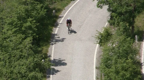 Cyclist going up on small road Stock Footage 36971635