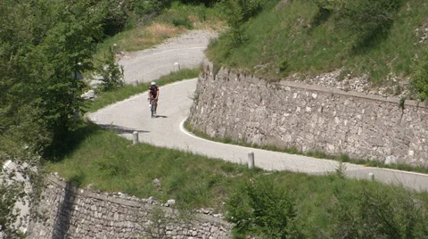 Cyclist going up on small road Stock-Footage 36971663