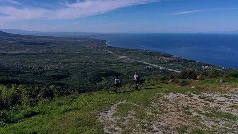 Cyclist going uphill on a beautiful paved mountain road in Greece Stock Footage 107663764