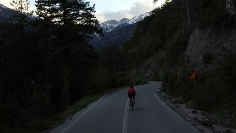 Cyclist going uphill on a beautiful paved mountain road in Greece Stock Footage 107777285