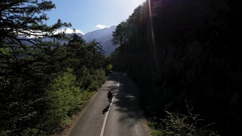 Cyclist going uphill on a beautiful paved mountain road in Greece Stock Footage 107777430