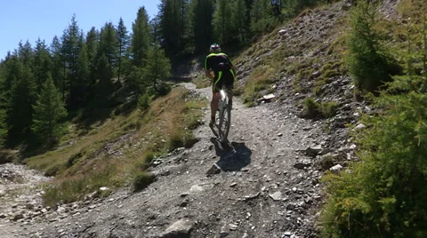 Cyclist going uphill on trail Stock-Footage 37586958