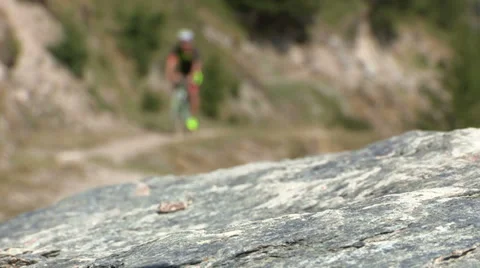 Cyclist going uphill on trail Stock Footage 37586987