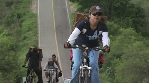 A Cyclist Greets the Camera As She Rides In A Pilgrimage for Christ Video stock 19228755