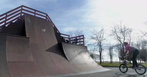 Cyclist jumps and waves his arms in the air Stock-Footage 102494597