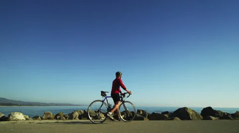 Cyclist looks at the Blue Sky Stock Footage 62889608