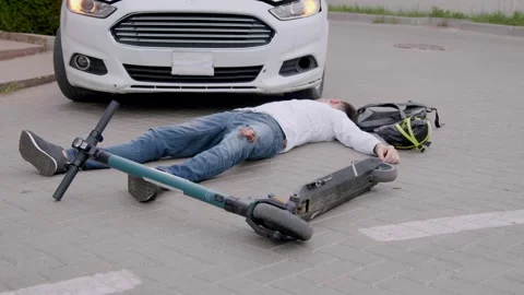 Cyclist lying on the asphalt after being fatally hit by a white luxury car. Man Stock Footage 246828641