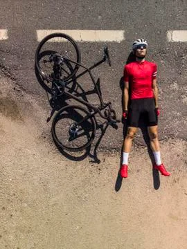 Cyclist lying on the road Stock Photos