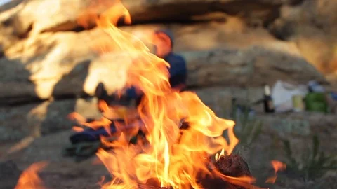 Cyclist makes camp behind a campfire Stock Footage 90820440