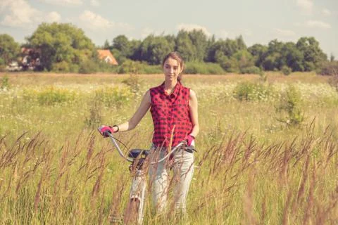 Cyclist on meadow Photos