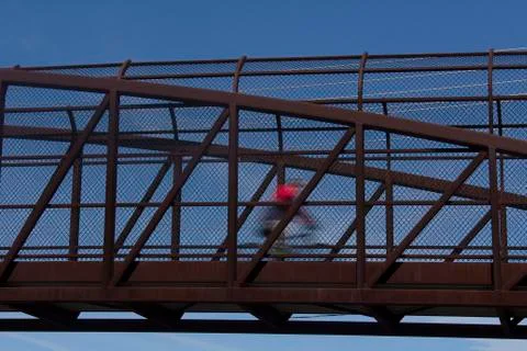 Cyclist in motion on bridge Stock Photos