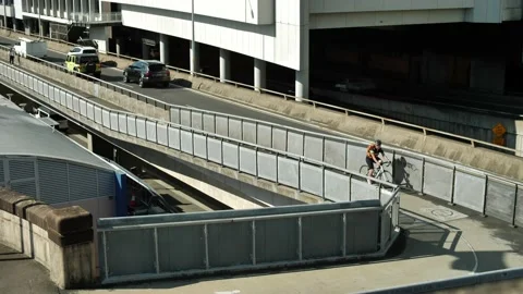 Cyclist next to traffic in Sydney CBD slow motion dolly 4K Video stock 236348787