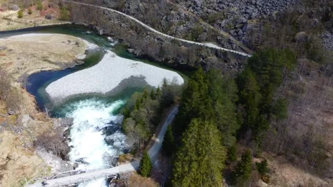 Cyclist over the Kardalsfossen Waterfall, Dynamic Shot - Myrdal, Norway Aerial Stock Footage 258288813