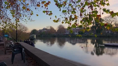 Cyclist Passing Riverside Path in Autumn Richmond Stock Footage 324699445