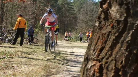 Cyclist passing start line Stock Footage 10804876