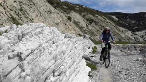 Cyclist on path to Cape Campbell lighthouse, Marlborough District, New Zealand. Video stock 134672386