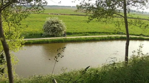 Cyclist on the path in the small Dutch town Sluis. Stock Footage 38004951