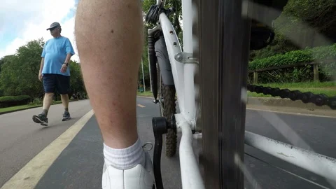 Cyclist pedals along the cycle path of the Ibirapuera Park Stock Footage 87551168