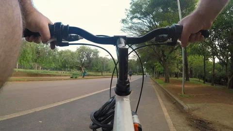 Cyclist pedals along the cycle path of the Ibirapuera Park Stock Footage 100991347