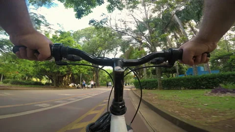 Cyclist pedals along the cycle path of the Ibirapuera Park Stock Footage 114253706