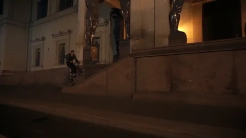 Cyclist performs a trick in the night city Stock-Footage 103045863