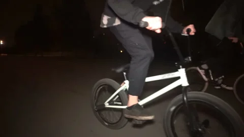 Cyclist performs a trick at night 스톡 동영상 103045031