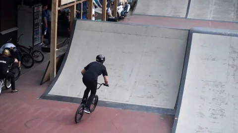 Cyclist performs trick in skate park on competition Video stock 103215982