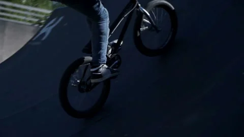 Cyclist performs trick on springboard Stock-Footage 102538550