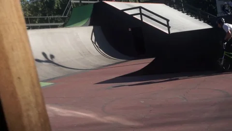 Cyclist performs a trick on a warm up in a skate park 스톡 동영상 103249890